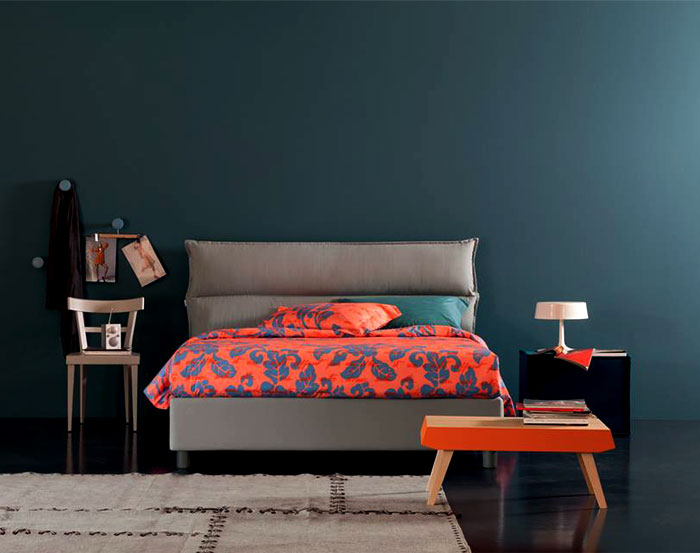 colored-bedroom-textiles-against-gray-walls